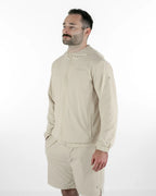 Man wearing a beige jacket and shorts on a white background