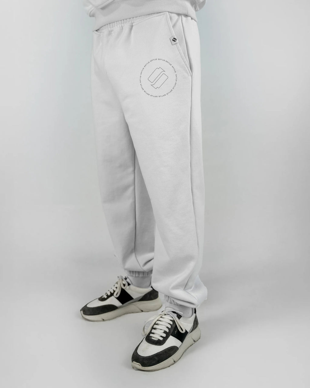 Light gray sweatpants with a logo on a white background