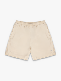 Tan shorts with "satus" branding in reflective print on a white background